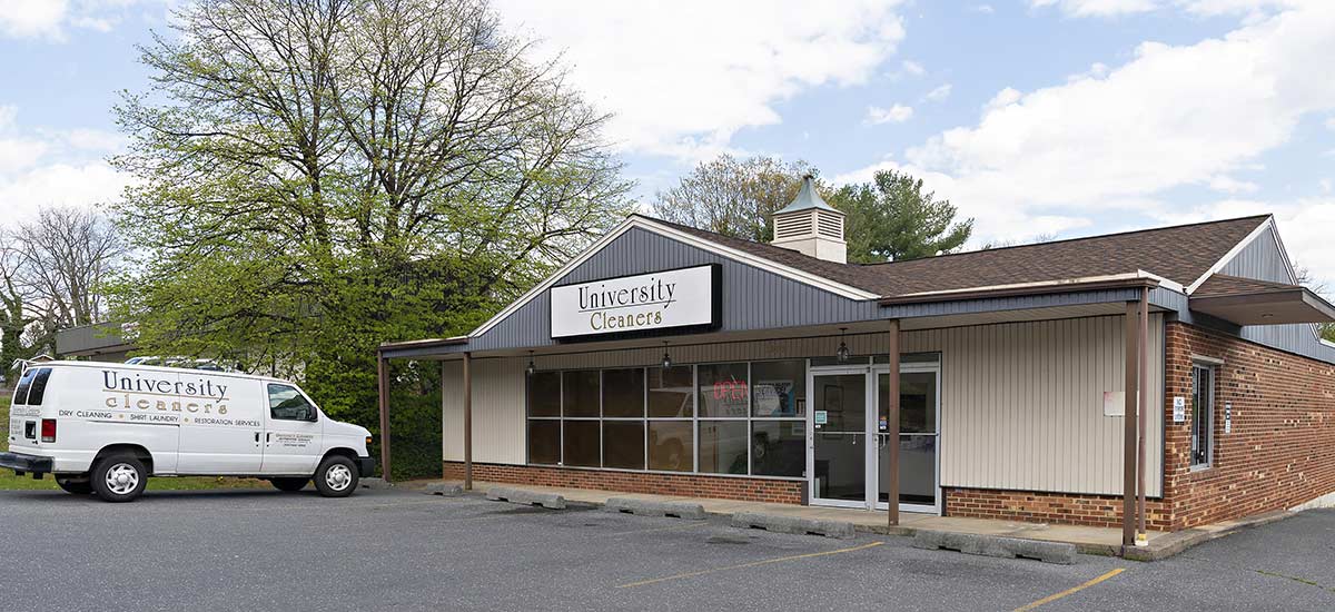 A small brick and siding building labeled 