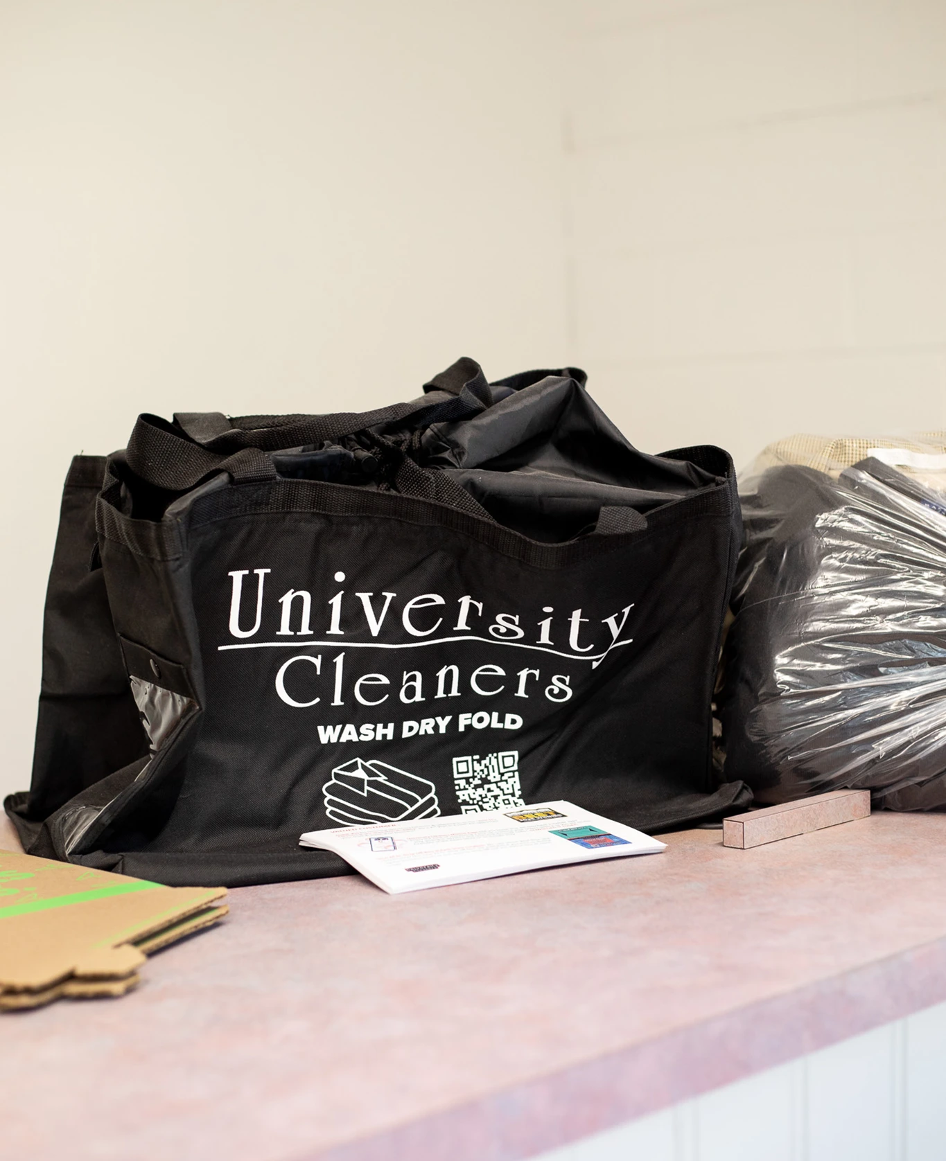 A black tote bag labeled 
