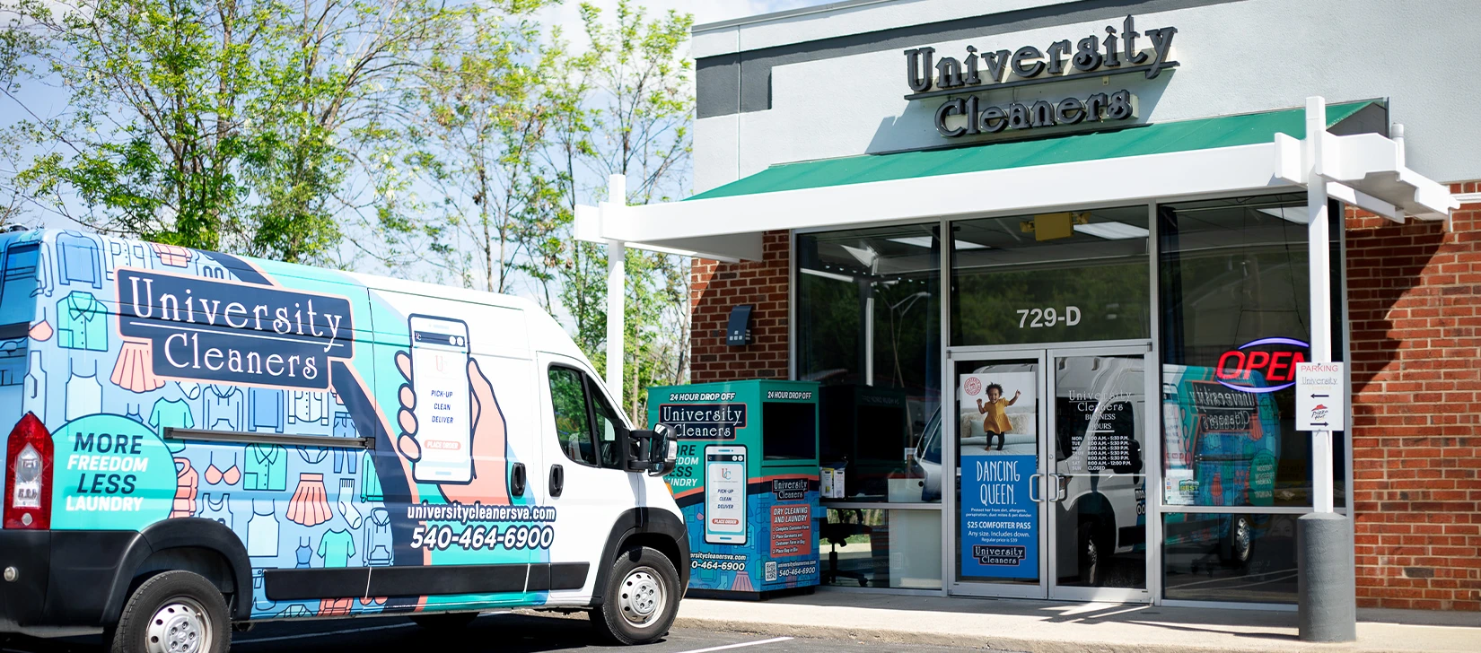 A University Cleaners van is parked outside a University Cleaners storefront with glass doors and an 